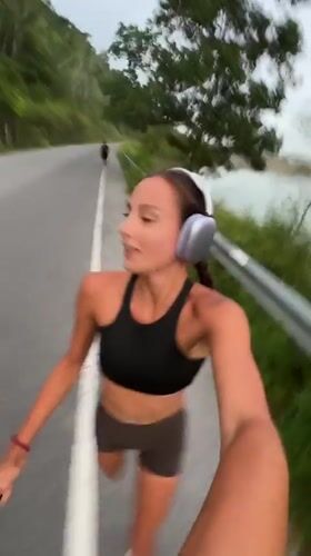 Morning jogger runs scenic waterfront route in Chalong, Thailand