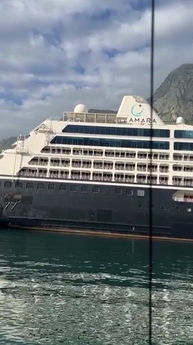 Sailboat passes AZAMARA cruise ship in Kotor waters