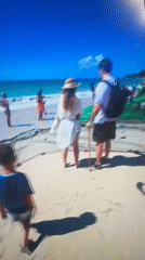 Tourists gather around fishing net at Bulgarian beach