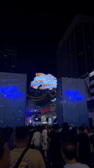 Crowd gathers at nighttime outdoor event in Kuala Lumpur