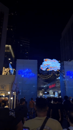 Crowd gathers at nighttime outdoor event in Kuala Lumpur
