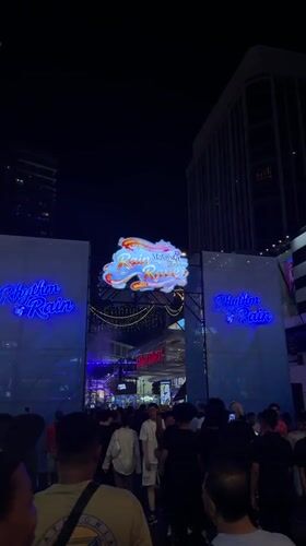 Crowd gathers at nighttime outdoor event in Kuala Lumpur