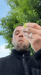 Man eats apple outdoors amid construction activity in Jerusalem