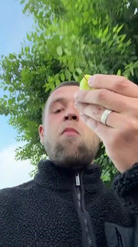 Man eats apple outdoors amid construction activity in Jerusalem