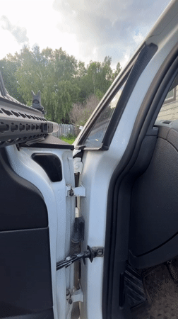 Armed individual recorded handling rifle in vehicle near Vasilyevo