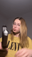 Woman styles hair with straightener in Kragujevac apartment