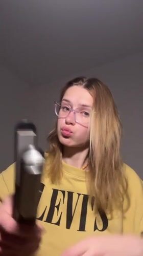 Woman styles hair with straightener in Kragujevac apartment