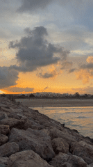 Sunset watcher observed on Sagunto breakwater during evening hours