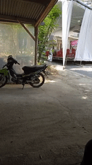 Neighborhood gathering in Kelurahan, motorcycles and a white tent