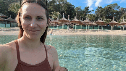 Woman takes beach selfie in shallow water, Turkey