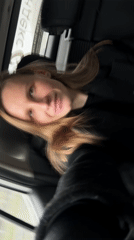 Woman rests in car back seat in Khimki