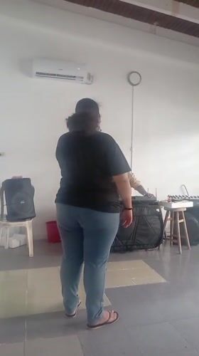 Woman sings with keyboardist in Juan Griego rehearsal space