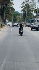 Morning street activity captured on tropical road in Thailand