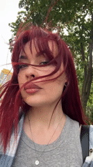 Woman with red hair observed in windy conditions, Tolyatti