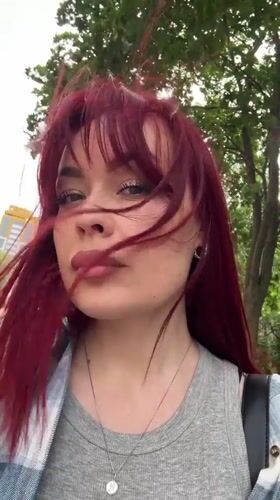 Woman with red hair observed in windy conditions, Tolyatti