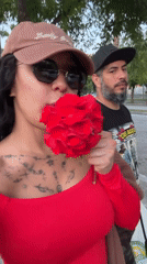 Woman with red flower spotted walking in Barcelona