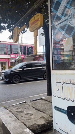 Street-side key cutting kiosk scene in Banjarbaru, Indonesia