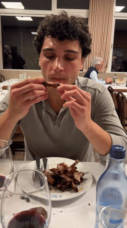 Young man enjoys hands-on rib dinner in Valença