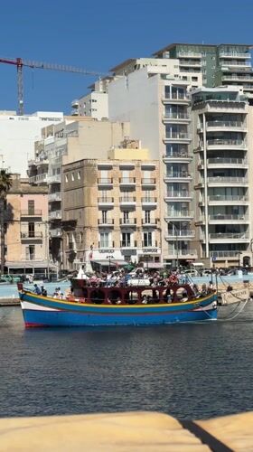Colorful passenger boat observed in Sliema harbor, Malta