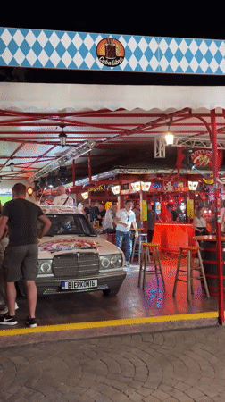 Decorated Mercedes parked outside busy Varna bar