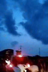 Witnesses document dusk-to-night transition near unidentified waterfront location
