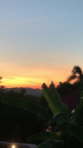 Vibrant sunset captured over tropical landscape in Thailand