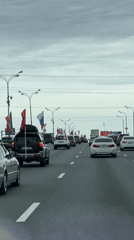 Flag-bearing vehicles travel Moscow highway May 9