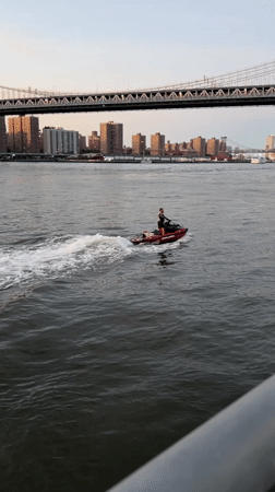 Brooklyn waterfront at golden hour — bridges, boats, and a pier proposal