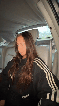 Woman in moving car observed during rainy night in Thailand