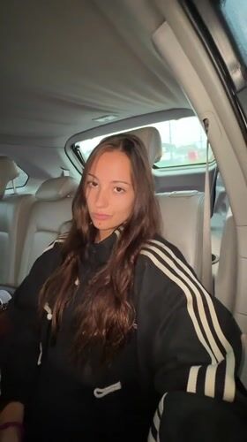 Woman in moving car observed during rainy night in Thailand