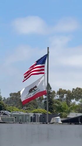Flags wave in evening breeze in Encinitas, California