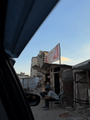 Makeshift shop open on a rubble-lined Gaza street