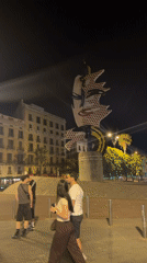 Colorful pop art sculpture glows at night in Barcelona