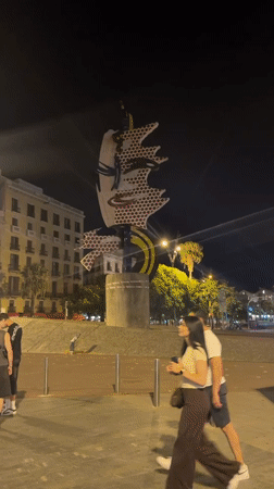 Colorful pop art sculpture glows at night in Barcelona