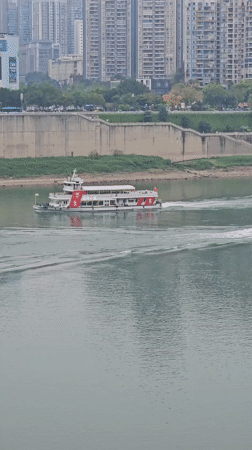 Passenger boats cruise Chongqing river during morning hours