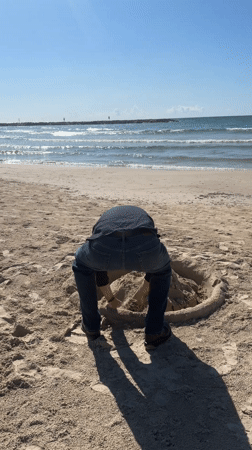 Man digs large hole on Tel Aviv beach