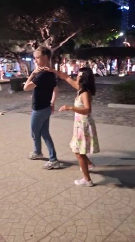 Couples partner dancing on a lit plaza in Nha Trang at night