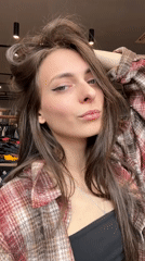 Woman films playful selfie video in Krasnoyarsk clothing store