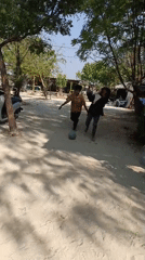 Scout kids, beach stalls, and iced drinks in coastal Cikal