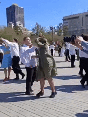 Costumed dancers perform choreographed routine in Novosibirsk public square