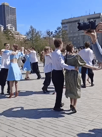 Costumed dancers perform choreographed routine in Novosibirsk public square