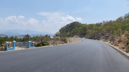 Construction site with fencing documented along curved road in Vietnam