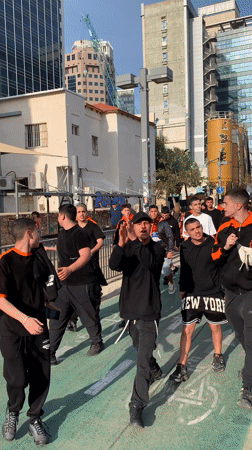 Group in team colors marches through Tel Aviv streets