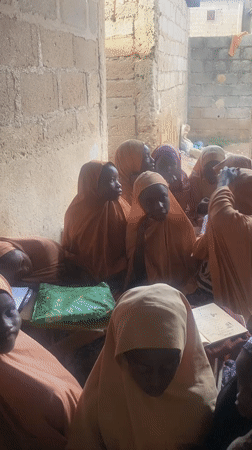 Informal learning and gathering at a concrete compound in Jos