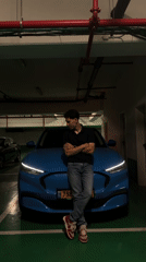 People pose with blue car in Jerusalem parking garage