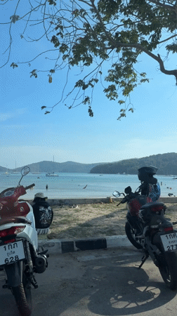 Vehicles parked along beach road in Tambon Wichit, Thailand