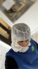 Worker adjusts protective gear during shift in Wissous