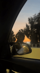 Driver films side mirror showing white car behind in Arica