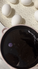 Person dyes eggs purple in Saint Petersburg home