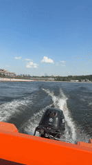 Orange boat travels across water near Kazan, Russia